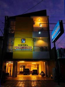 a building with a sign on the side of it at Hotel Poncowinatan - Tugu in Yogyakarta