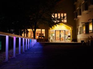 a store front at night with purple lights at Asama Kogen Hotel in Tsumagoi