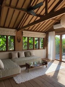 a living room with a couch and a table at Modjo Apartment Bingin in Uluwatu
