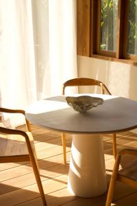 a white table and chairs in a room at Modjo Apartment Bingin in Uluwatu +4 photos