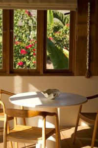 a table and chairs in a room with a window at Modjo Apartment Bingin in Uluwatu