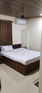a bedroom with a large bed in a room at Hansh Residency in Mumbai