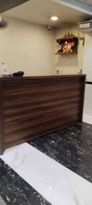 a wooden counter top in a room with a wall at Hansh Residency in Mumbai