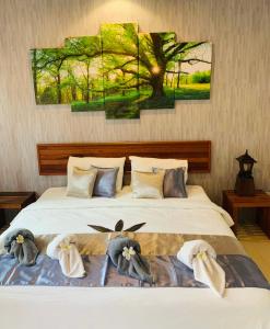 a bedroom with a bed with three birds on it at Andawa Lanta Resort in Ko Lanta