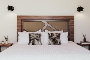 a bedroom with a large white bed with two pillows at San Miguel Hills in Ensenada