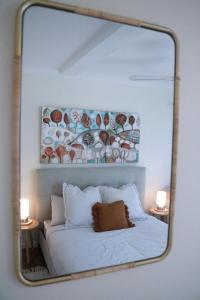 a mirror reflection of a bed in a bedroom at Seascape Retreat - Time to Slow Down - Suits Couples or Family with Kids with 2 sleeping spaces in Agnes Water