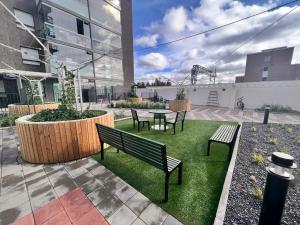 a patio with benches and a table in a courtyard at 2 Room / Central Railway / Free parking / Sauna in Oulu