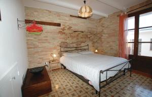1 dormitorio con cama y pared de ladrillo en Casale Barbagianni, en Senigallia