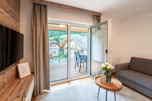 ein Wohnzimmer mit einem Sofa und einem großen Fenster in der Unterkunft Apartment Ski&Nature "Fanningberg" in Mauterndorf