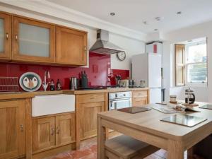 a kitchen with wooden cabinets and a wooden table at The Third in Edinburgh