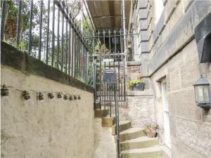 an alley with stairs and a wrought iron fence at The Third in Edinburgh
