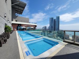 a swimming pool on the roof of a building at Best Travel in Haeundae with best location in Busan