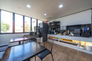 a kitchen with tables and chairs in a room at HOTEL STAY AYANA DAEJEON in Daejeon