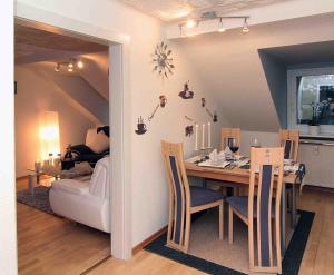 a dining room and living room with a table and chairs at Ferienwohnung Brigitte Leist in Sankt Wendel