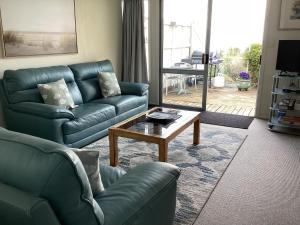 a living room with a couch and a coffee table at Absolutely in Kaikoura