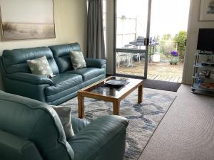 a living room with a couch and a coffee table at Spectacular Views Convenient & Affordable in Kaikoura