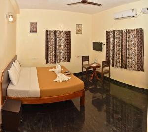 a bedroom with a bed with a bird on it at ART Resort & Farm House in Mahabalipuram