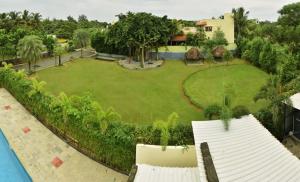 an aerial view of a yard with a pool at ART Resort & Farm House in Mahabalipuram