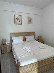 a bedroom with a large bed with two towels on it at Luxury Apartments and Studios Boulevard G Enescu Suceava in Suceava +55 photos