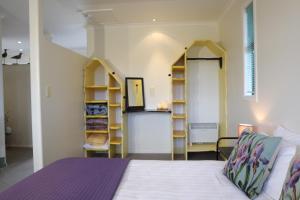 a bedroom with a bed and shelves in it at Absolutely in Kaikoura