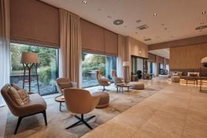 a lobby of a hotel with chairs and tables at AC Hotel by Marriott Berlin Humboldthain Park in Berlin