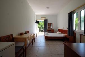 a living room with a couch and a table at MIRSINI HOTEL in Plomari