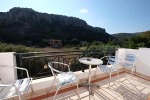 a balcony with chairs and a table with a view at MIRSINI HOTEL in Plomari