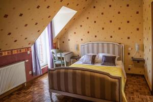 a bedroom with a large bed in a attic at Holistica - Bien être in Saint-Fargeau