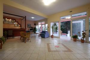 a living room with a lobby with a table and chairs at MIRSINI HOTEL in Plomari