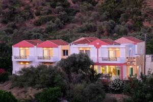 a house on a hill with its lights on at MIRSINI HOTEL in Plomari