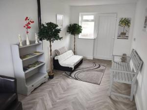 a living room with a couch and a chair at The Cubley Retreat in Sheffield