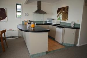 a kitchen with a black counter top in a room at Spectacular Views, Convenient, Affordable - KK17129 in Kaikoura
