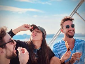 a group of people sitting on a boat eating food at boat and breakfast in Bari