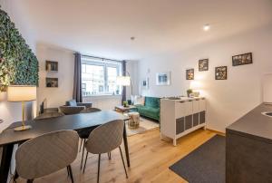 a living room and dining room with a table and chairs at Modern City Center Apartment in Vienna