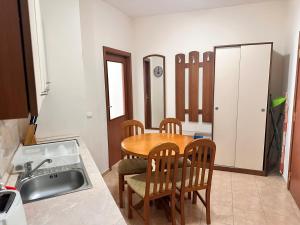 a kitchen with a table and chairs and a sink at Spacious studio sleeps 4 in Flora main building 706A in Borovets