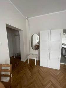 a room with a white cabinet and a mirror at KART APART 2 in Rīga