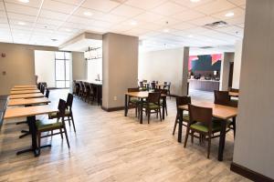 a dining room with wooden tables and chairs at Fairfield Inn & Suites Atlanta Airport North in Atlanta