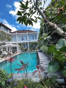 a swimming pool in front of a house at Bingin Inn in Uluwatu