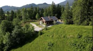 an aerial view of a house on a green field at Gemütliches Berg-Chalet mit Panoramablick in Bayrischzell