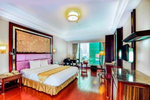a bedroom with a large bed and a large window at Grand Plaza Hanoi Hotel in Hanoi