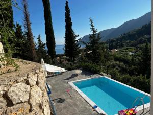 a swimming pool with a view of the mountains at Katerinas Village Supreme Villas with private pool in Agios Nikitas