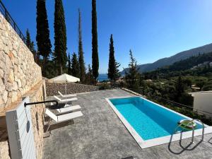 a swimming pool on the side of a house at Katerinas Village Supreme Villas with private pool in Agios Nikitas +18 photos