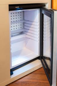an empty refrigerator with its door open at Hotel Augustus in Rimini