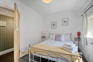 1 dormitorio con 1 cama con toallas en Large family house in Worthing - 5 mins from beach en Worthing