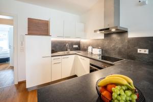 a kitchen with a bowl of fruit on a counter at Garten-Appartement Ski&Nature "Kesselspitze" in Mauterndorf