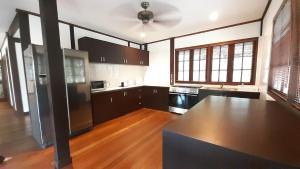 a kitchen with black cabinets and a black counter top at Nongsa Village in Nongsa