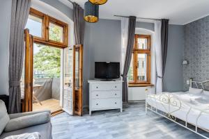 1 dormitorio con cama y vestidor con TV en Very Berry - Glogowska 35m10 - MTP Apartments - self check in 24h -, en Poznan
