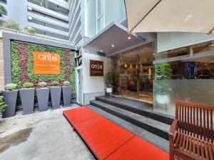 a store front with a red carpet in front at On 8 Sukhumvit Nana Bangkok by Compass Hospitality in Bangkok
