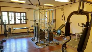 a room with a gym with several tread machines at Nongsa Village in Nongsa