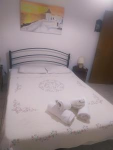 a bedroom with a bed with towels on it at Sofia-Marina Guest House in Xanthi